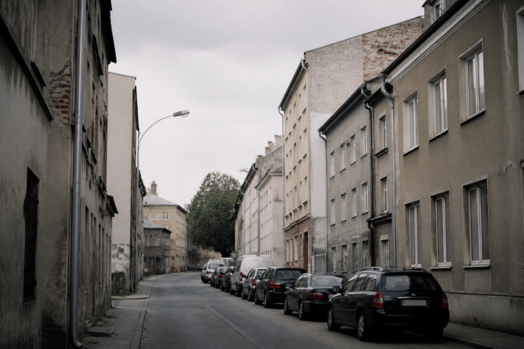 Rue urbaine avec immeubles gris sous ciel nuageux